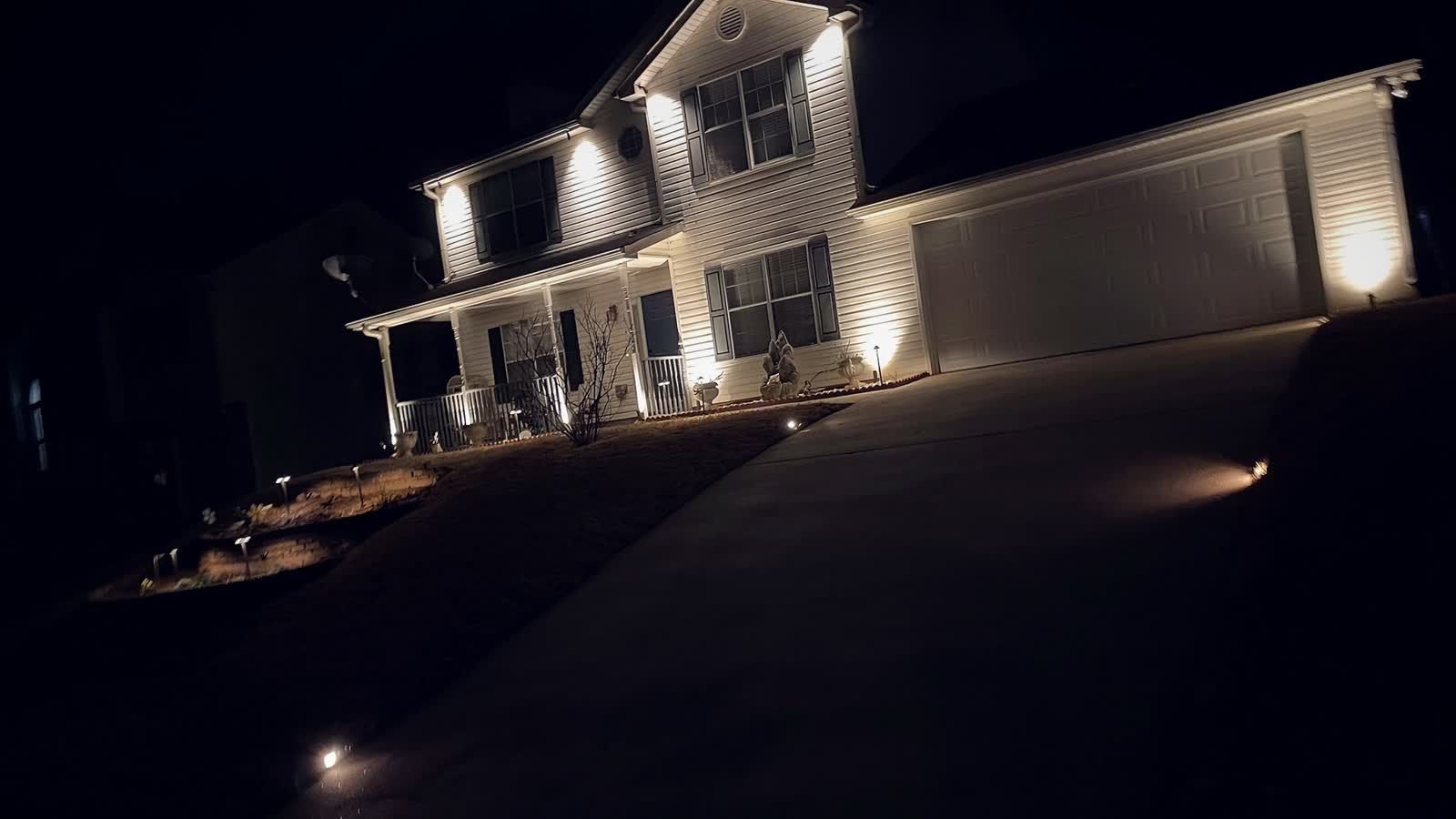 A house on a sloped Vinings lot with lit facade