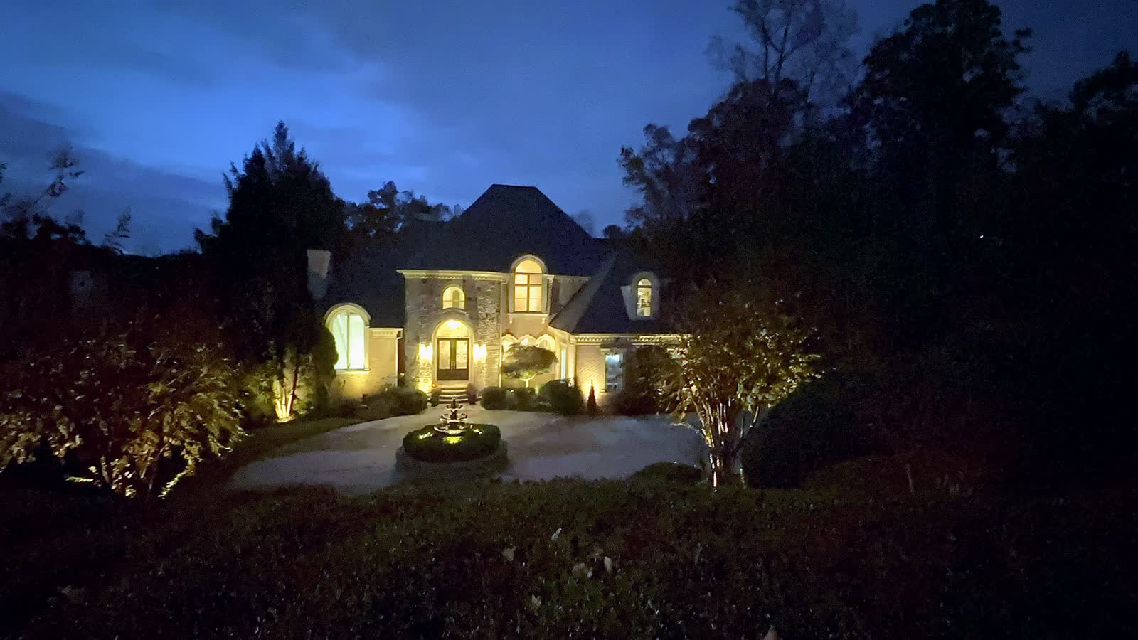 A home and garden lit at blue hour